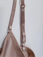 Close-up of the adjustable, reinforced shoulder straps and fine stitching of a Velmora bodysuit, emphasizing the premium hardware and comfort-first design.