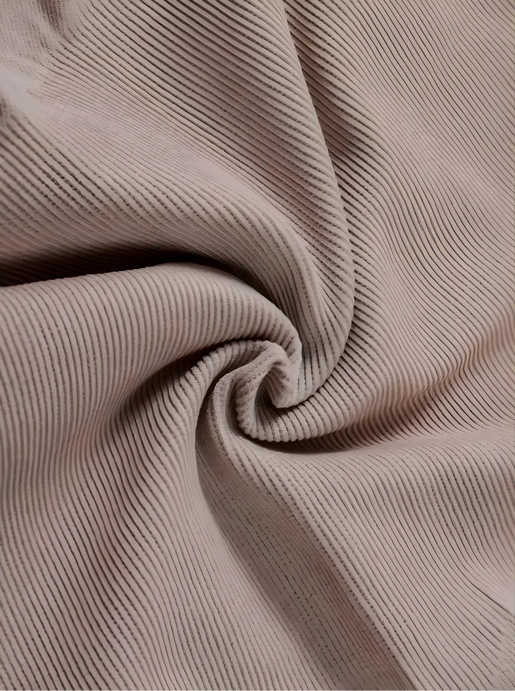 A macro close-up of Velmora’s high-quality, breathable ribbed fabric in a soft mauve tone, showing the intricate weave designed for maximum stretch and firm support.