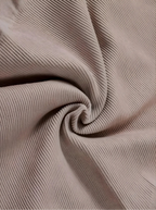 A macro close-up of Velmora’s high-quality, breathable ribbed fabric in a soft mauve tone, showing the intricate weave designed for maximum stretch and firm support.