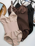 Flat lay photography of three Velmora bodysuits in Black, Chocolate, and Sand, showing the seamless construction and adjustable gusset closure for daily convenience.